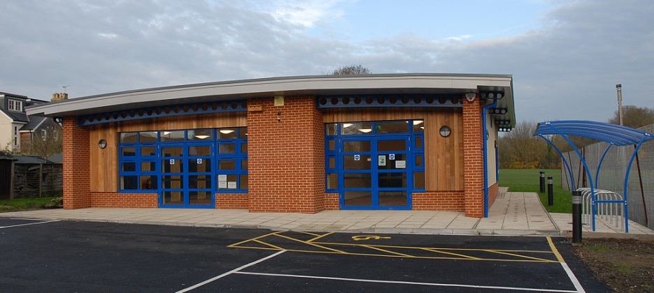 Brick single storey building with blue metal doors and windows